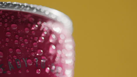 Close-Up-Of-Condensation-Droplets-On-Revolving-Takeaway-Can-Of-Cold-Beer-Or-Soft-Drink-Against-Yellow-Background-With-Copy-Space-3